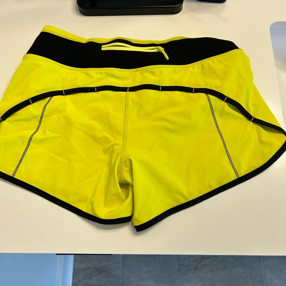 Neon yellow size 4, 4 inch Lululemon shorts. Barely worn. Excellent condition!